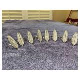 Set of (8) heavier silver-tone feather motif napkins rings
