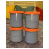 Set of (4) baby blue La Fermière ceramic yogurt pots feature a charming embossed sun design and orange lids - 3-1/4” tall