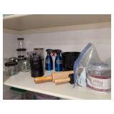 Shelf of various kitchen items - canning jars, rolling pins, flour sifter, utensil caddy