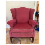 Pyramid Manufacturing (Memphis) wing back chair with textured upholstery and a decorative multi-colored braided trim along the seat cushion