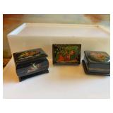 Three miniature Russian black enamel hand-painted boxes. One is signed.