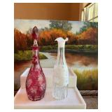 Vintage Cranberry Nachtmann cut to clear Crystal decanter. Does have a chip on rim as shown. ￼ Also a white overlay cut to clear grapes hand blown decanter without stopper