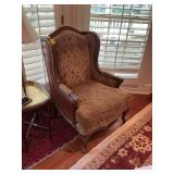 Vintage Camelback chair with faux leather and brads on the sides and back. 29” x 32” x 41” The seat height is 18 inches.