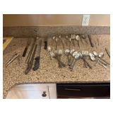 Assortment of silver plated silverware, and Cuisinart 16 pc set, along with a few knives and other kitchen accessories