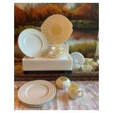 18 piece collection of Irish Belleek porcelain china. Very delicate. 1- 10 inch platter. 4- 8 inch plates, six saucers with 5 cups, a creamer and unlidded sugar bowl. The insides of these are a pale y