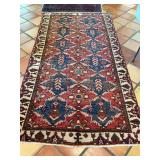 Well loved antique Persian rug in blues and red. See photos for condition.  58” x 114”.