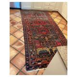 Well loved Persian rug in reds and blues. See photos for condition. 57 1/2” x 128 inches