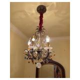Small multicolored chandelier in bathroom will be taken down before pick up