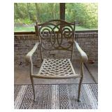 Cast aluminum patio armchair in a light taupe finish with a distinctive scrollwork backrest design and a lattice-woven seat base with Plantation Pattern cushion
