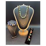 Selection of costume jewelry featuring a bracelet with dangling, semi-precious gemstone nuggets, blue/white glass beaded bracelet, gemstone necklaces