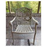 Cast aluminum patio armchair in a light taupe finish with a distinctive scrollwork backrest design and a lattice-woven seat base with Plantation Pattern cushion