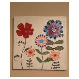 Mixed-media canvas featuring whimsical, folk-art style flowers in shades of red, orange, yellow, and blue against a textured cream background - 23-1/2” square