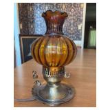 Vintage amber glass table lamp featuring a ribbed body and a ruffled chimney rim set upon a brass-finished base - 11” tall