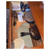 Contents of top drawer of hutch in dining room - silverplate, mirror displays, trivets and more