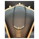 Vintage Brighton braided leather choker necklace featuring a rectangular silver-tone pendant with an embossed floral design
