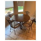 Very nice wrought iron base table with faux marble top and (4) wrought iron base chairs with thick upholstery seating