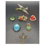 Grouping of (7) uniquely designed brooches and pendants