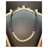 Stylish choker featuring a black braided leather cord paired with a luminous front strand of white pearls and ornate silver end beads