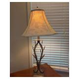 Rustic metal table lamp with a distinctive arched stem design adorned with forged leaf accents and a textured square base, topped with a square fabric shade featuring a subtle botanical pattern - 22-3