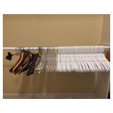 Large grouping of wire, wood and plastic hangers
