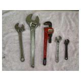 Grouping of various size crescent wrenches and a 14” pipe wrench