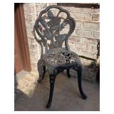 Cast aluminum bistro chair with a decorative rose and leaf motif on the backrest and an openwork filigree seat - 15”D x 35 tall