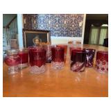 Grouping of cranberry glass in various designs and patterns - all are approx. 4” tall