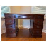 Vintage mahogany twin pedestal kneehole desk features a nine-drawer configuration with brass-toned bail pull hardware - 46 x 23 x 20 tall
