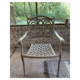 Cast aluminum patio armchair in a light taupe finish with a distinctive scrollwork backrest design and a lattice-woven seat base with Plantation Pattern cushion