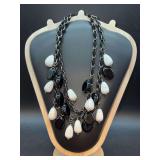 Double-strand black and white beaded statement necklace featuring teardrop-shaped beads with marbling affect