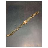 Vintage gold-tone link bracelet featuring an oval carved cameo center stone