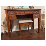 Warm brown wooden vanity desk and matching padded stool set featuring multiple storage drawers with simple round knobs - no mirror - OTHER CONTENTS NOT INCLUDED