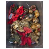 Storage container of red & gold Christmas ornaments and decor
