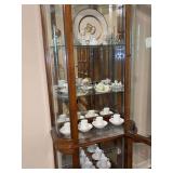 Contents of display cabinet - Precious Moments, Irish Liqueur Glasses, fine china cup & saucer sets (Crown, 2 cups on next to bottom shelf are Tiffany and 1 is cracked, mini tea sets)