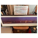 Framed panoramic print titled Memphis, Tennessee featuring a nighttime view of Memphis, skyline and bridge reflecting over water. 41” x 14 1/2”., A canvas framed vacinity print 25 1/2 in.² and a 