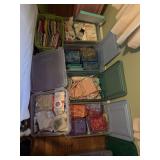 Six containers of sewing notions and quilting material
