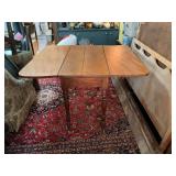 Vintage wooden drop leaf table with turn legs with a warm amber finish. 47“ x 43“ opened 29 inches tall. 20 inches wide with the leaves down.