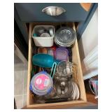 Three drawers right of stove with kitchenware/utensils/ and baking items