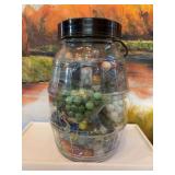 Large glass barrel jar full of marbles. 7“ x 10“ many of these vintage