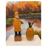 10 1/2 inch Cigar Beach House hand carved sea captain with yellow slicker and a wooden pineapple