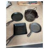 ￼ Four miniature cast-iron pieces. Two Griswold, One Wagner