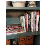 Assortment of books on third shelf in den.