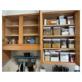 Assortment of lock lid canisters and other items in cabinet right of sink and on bottom shelf above sink.