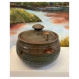Covered pottery bowl with lid in blues and greens . 7“ x 6“.