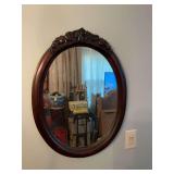 Antique mahogany oval mirror. 21” x 28”.. does show a few mild silvering spots.