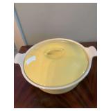 Le Creuset round cast iron enamel covered yellow and white dish. Made in France. 9 1/2 inch round.