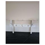 Rustic, white-washed wooden wall hung shelf with pegs and center panel with cut-out star and moon. 35.5 x 9 x 20.5 in tall.