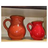Two Italian made Pottery pitchers. 5.25 inch tall red color and 6.75 rust color. Sticker residue on red pitcher as shown.