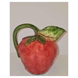 Hand-painted ceramic strawberry pouring pitcher. Make her unknown as the bottom is covered with a protective felt piece. 7 in tall including handle