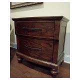 La Jolla 2 drawer bedroom nightstand Code B1033B-040. Ranchero Brown, hardwood solids and walnut veneer with bronze strap accents. Royal Classics by New Classic Furniture. Smooth full-extension ball-b